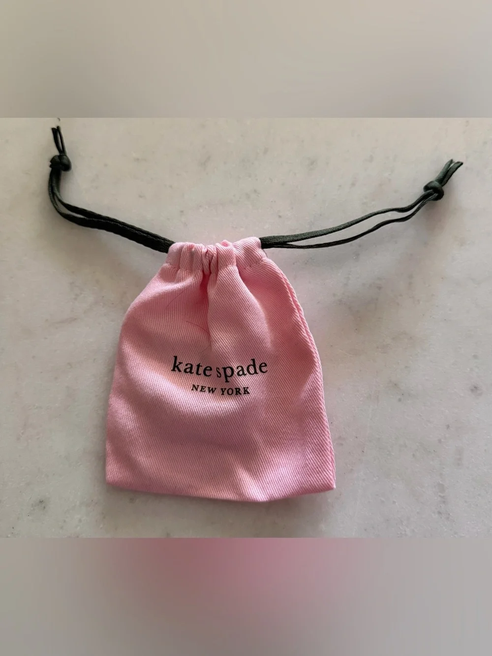 kate spade Pink Drawstring Pouch with Gold Hoop Earrings
